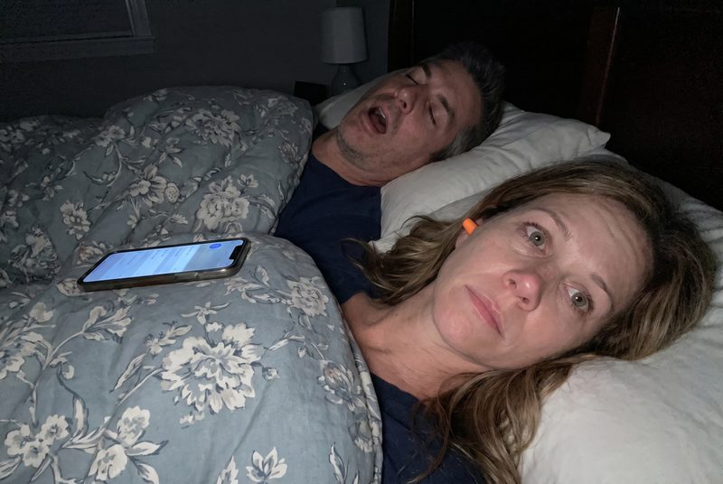 3am, she's still awake next to him with an earplug in